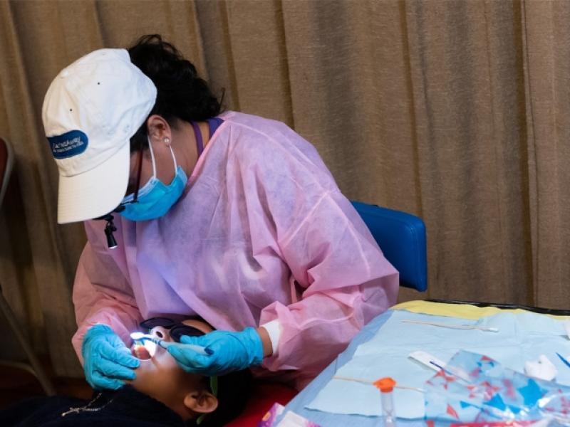 "School Dental Program Prevents 80 Percent of Cavities with One-Time, Non-Invasive Treatment; Photo of someone getting dental treatment"