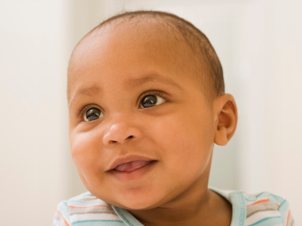 "Infants Outperform AI in Commonsense Psychology; Head shot of baby smiling. Credit: Jupiterimages/Getty Images"