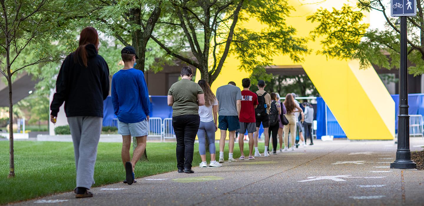 Pitt’s Pandemic Practices Could Serve as an Example for Other Institutions; Picture of students waiting in line