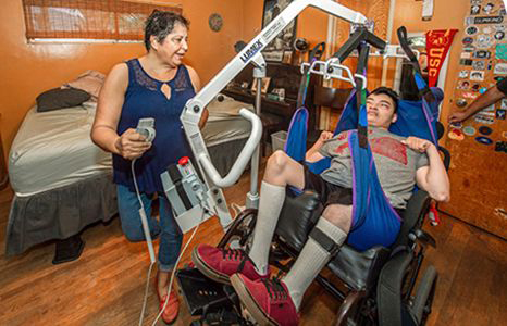 Margarita Lopez helps her son Emilio Lopez, 22, in the mornings before starting her own day as a USC student.