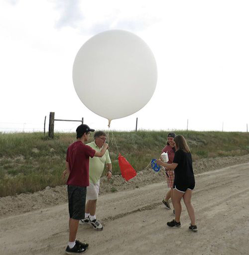 Texas A&M students release a weather balloon into the sky.