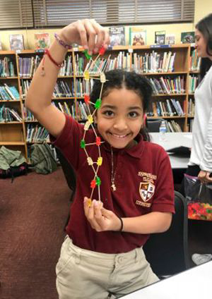 Jasiah Simpson holds a DNA model made of gummy bears