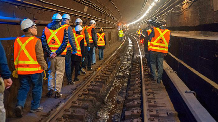 Image: An expert group of engineers tour the Canarsie Tunnel. 