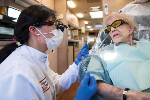 Gloria Schwed, a dental patient at Hollenbeck Palms and dental student Lisa Hou.