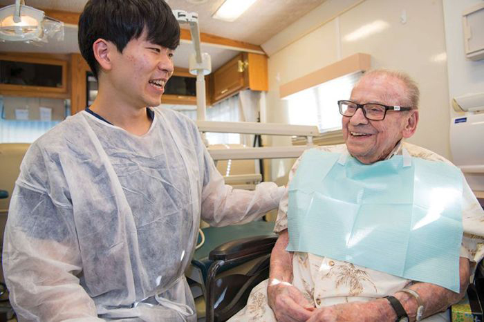 Collin Kyongmin Lee shares a laugh with Norman Beals, who is 102. 
