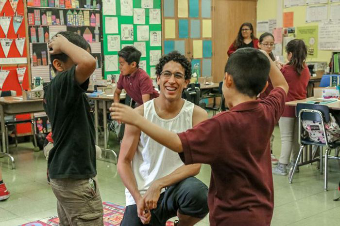 Senior Alvaro Montelongo talks with two of his students.