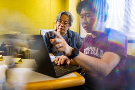 "Jong Han illustrates his quantum avalanche theory in his Fronczak Hall office. He has demonstrated that an electric field can trigger a quantum avalanche that allows electrons to move between bands. Credit: Douglas Levere, University at Buffalo"