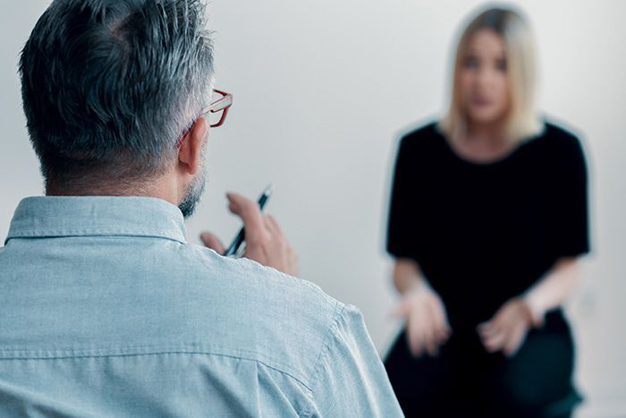 Image of counselor speaking with young woman.