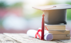 A graduation cap on a stack of books