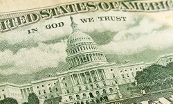 Close-up of a dollar bill showing the US capitol