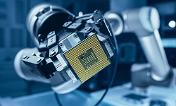 robotic arm holds a computer chip