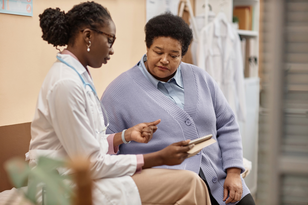 Doctor with a clipboard talking with a patient. 