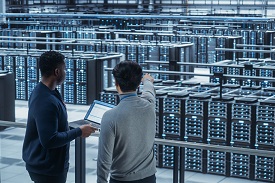 Two individuals in a data center
