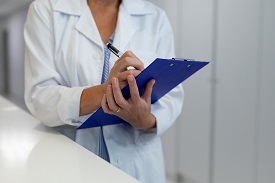A doctor holding a clipboard
