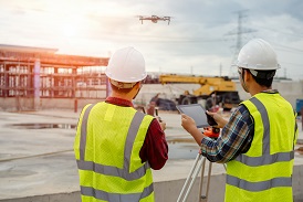 Construction workers using a drone
