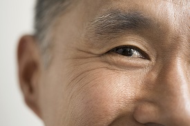 Close-up of an eye of a man who's smiling