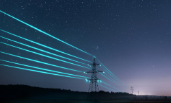tansformer with powerlines lit blue at night