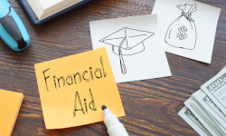 Desk with post it note that says Financial Aid