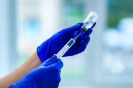 someone using a needle and vial