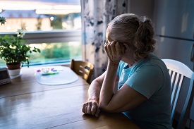 Woman sitting at a table looking out a window