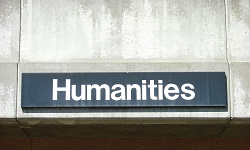 A humanities sign on a building wall