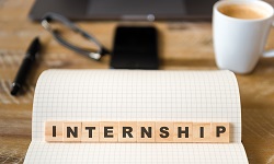 The word internship spelled out using Scrabble tiles