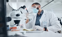 Scientists looking through a microscope