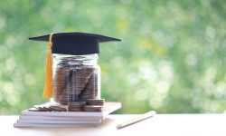Money in a jar with a graduation cap