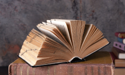 a large old book with the pages open in an accordion style