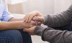 A therapist holding a patient's hands