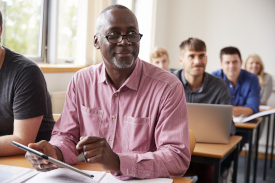 Man sitting at a desk taking a class