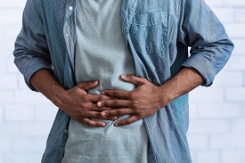 A person clutching their stomach in pain
