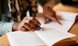 Person of color studying