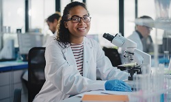 STEM student sitting at microscope
