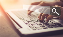 A search bar superimposed over a laptop
