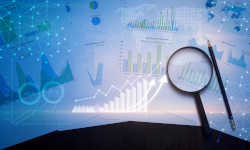 Charts layed on a table with a pencil and a magnifying glass