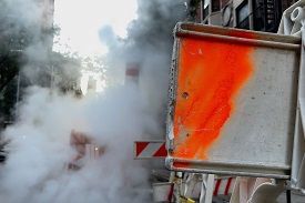 Steam coming out a pipe at a repair site