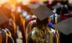 audience of graduates with gowns and caps