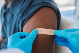 Person receiving bandage after getting vaccinated