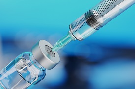 a needle inserted into a vial