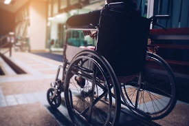 View of a person sitting in a wheelchair from the behind