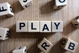 cubes with letters on all sides spell out the word play