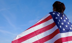 Young woman draped in an American flag