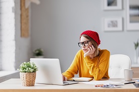 Woman looking despondently at a computer