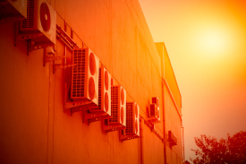 A ro of air conditioning units in a red hot day