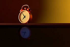 Alarm clock on a shelf with morning light in the top half and night light in the bottom half
