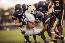 Picture of someone getting tackled in american football