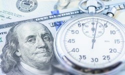 100 dollar USD bills with stop watch