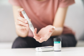 A person checking their insulin
