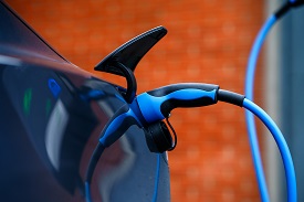 an electric vehicle with a charging cable plugged in
